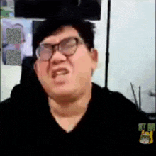 a man wearing glasses is making a funny face in a video
