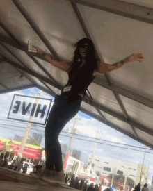 a woman stands under a tent with a sign that says hiv on it