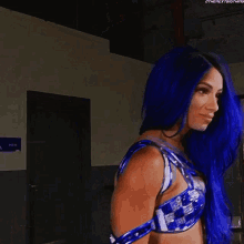 a woman with blue hair is wearing a blue bra