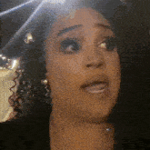 a close up of a woman with curly hair making a face