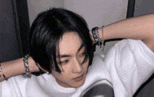 a close up of a person wearing a white shirt with the letter a on it