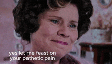 a close up of a woman 's face with the words yes let me feast on your pathetic pain below her
