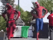 deadpool and spider-man are dancing together on a stage .