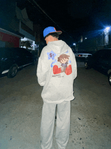a person wearing a hoodie with the word solitude on the back