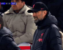 a man wearing a nike hat and a jacket that says ' axa ' on it