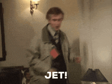 a man in a suit and tie says " jet " in a blurry photo