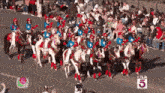 a group of people riding horses in a parade with ktla 5 on the bottom right