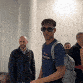 a man wearing sunglasses and a t-shirt that says champions