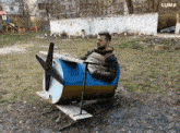 a man is sitting in a barrel that looks like a small airplane