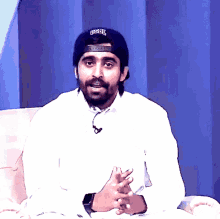 a man with a beard wearing a hat that says gsdjl on it