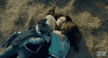 two women hugging each other in a field with the letters hw visible