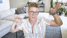 a man wearing glasses and a striped shirt says " have fun "
