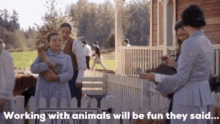 a group of people standing in front of a sign that says working with animals will be fun they said ..