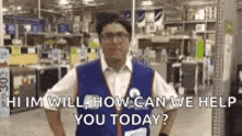 a man in a vest is standing in a store with his hands on his hips .