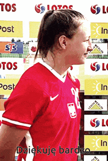 a woman in a red jersey with the number 12 on the front
