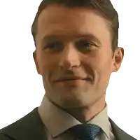 a man in a suit and tie looks at the camera
