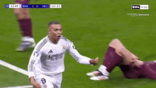 two soccer players are hugging each other on a field .
