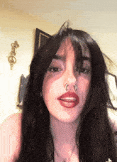 a girl with a nose ring and red lips
