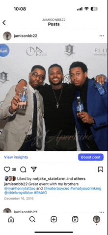 a group of men are posing for a picture with bottles of royal blue