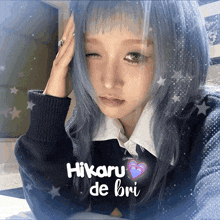 a girl with blue hair has the name hikaru de bri on her face