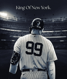 a baseball player with the number 99 on his back stands in front of a stadium