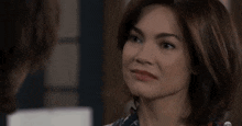 a close up of a woman 's face looking at another woman 's face .
