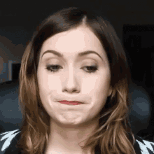 a woman is making a funny face with her mouth open and making a funny face with her mouth open .