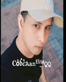 a man wearing a hat and a black shirt with codeaan elite qq written on the bottom