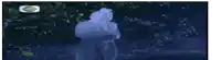 a blurry picture of a person in a blue hoodie standing in the dark .