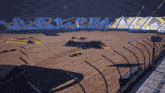 an aerial view of a dirt track with a checkered wall behind it that says ' arizona '