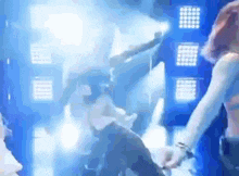 a blurry picture of a group of people dancing on a stage .