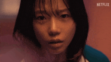 a girl is crying with a netflix logo in the background