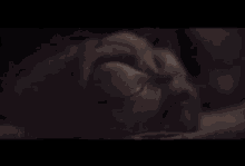 a close up of a statue of a person sleeping with their eyes closed .