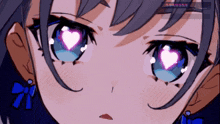 a close up of a girl 's eyes with a heart in them