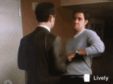 two men are standing next to each other and shaking hands .