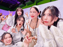 a group of women are posing for a picture and one of them is wearing a white shirt that says lg