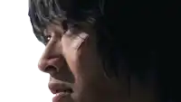 a close up of a man 's face with a bloody wound on his face