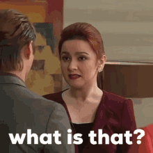 a woman talking to a man with the words " what is that " on the bottom