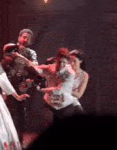 a man is holding a camera while a woman holds a man 's arm