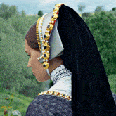 a woman wearing a black veil and a white hat with gold beads