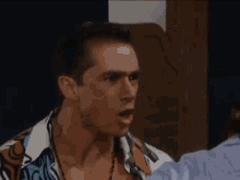 two men are standing next to each other in a room and having a fight .