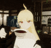 a girl with blonde hair holds a cup of tea