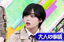 a girl with short black hair is standing in front of a sign that says ' 大人 の 事情 '