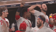 a group of philadelphia phillies players celebrate a win