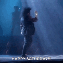 a man is dancing on a stage with the words happy saturday written on the bottom