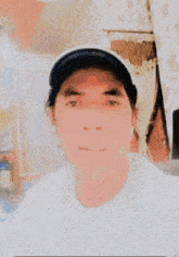 a man wearing a baseball cap and a white shirt is standing on a sidewalk