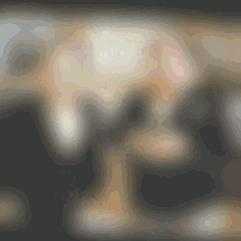 a blurry picture of two people shaking hands in a dark room