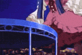 a woman in a pink dress is sitting on a blue carousel