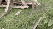 a wooden structure is sitting on top of a grassy field