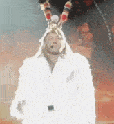 a man wearing a white fur coat and a crown